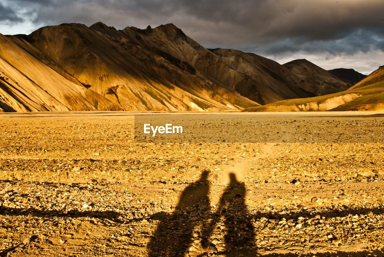 Shadow of man on mountain against sky