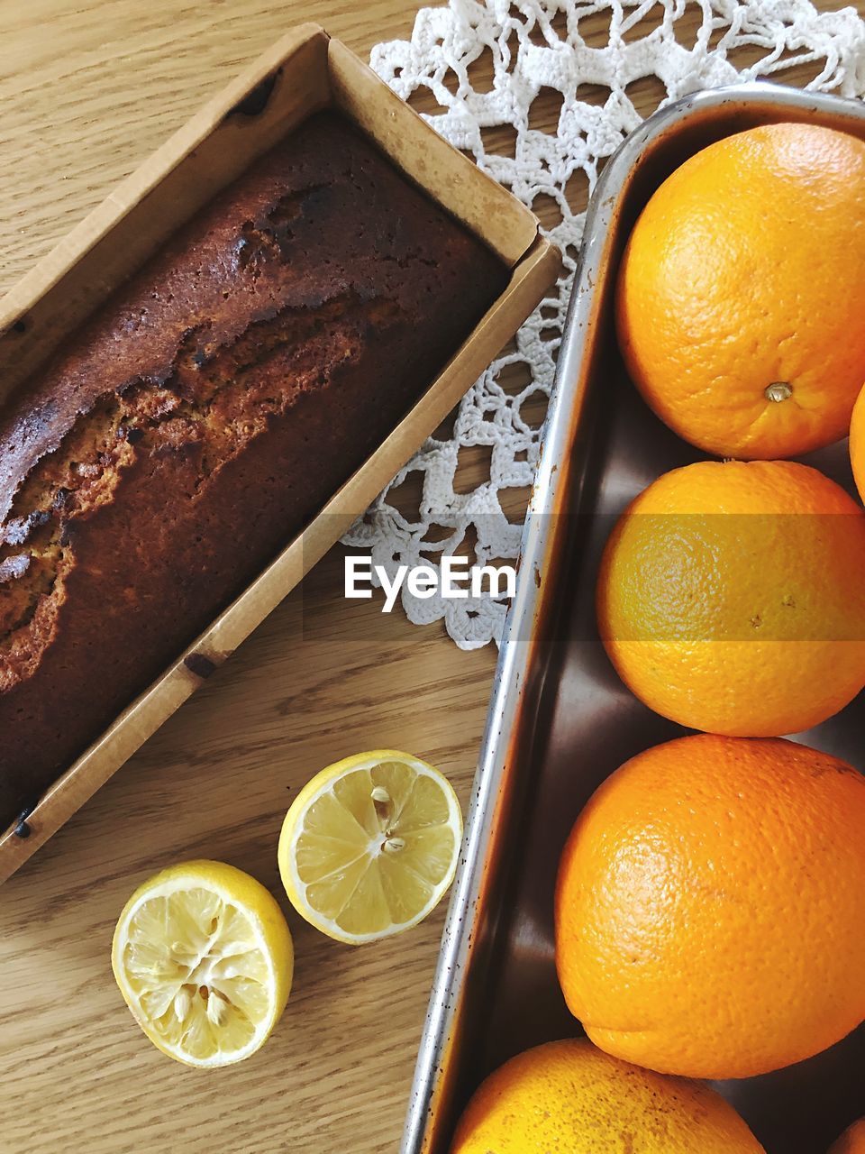 High angle view of oranges and orang cake on table