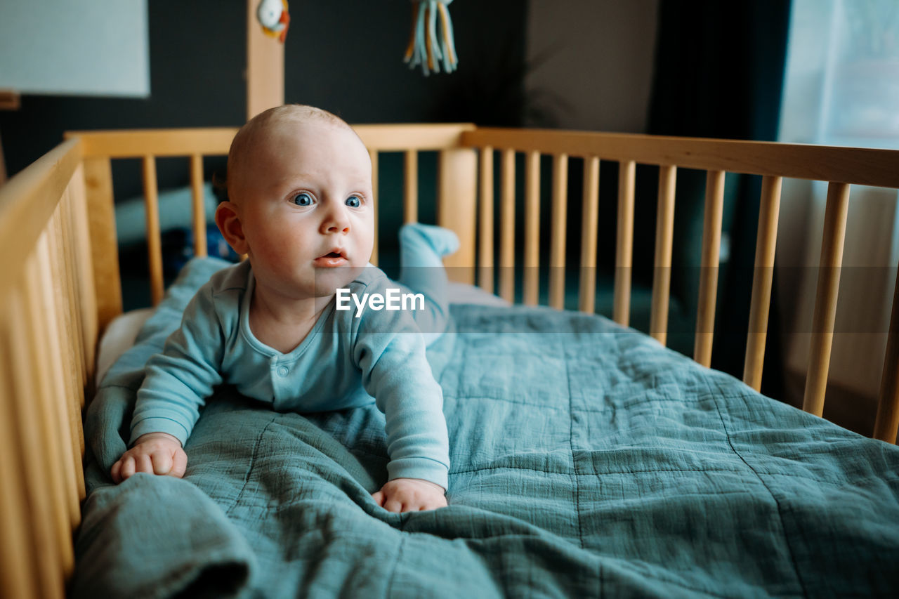 Cute baby looking away in crib