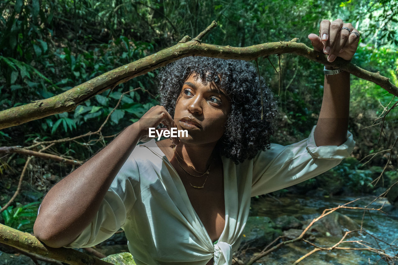 Woman looking away in forest