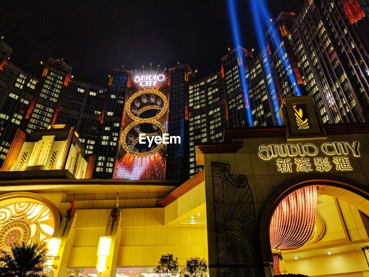 LOW ANGLE VIEW OF ILLUMINATED BUILDINGS AT NIGHT