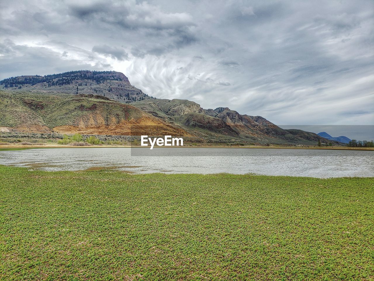 SCENIC VIEW OF LAKE AGAINST MOUNTAIN RANGE