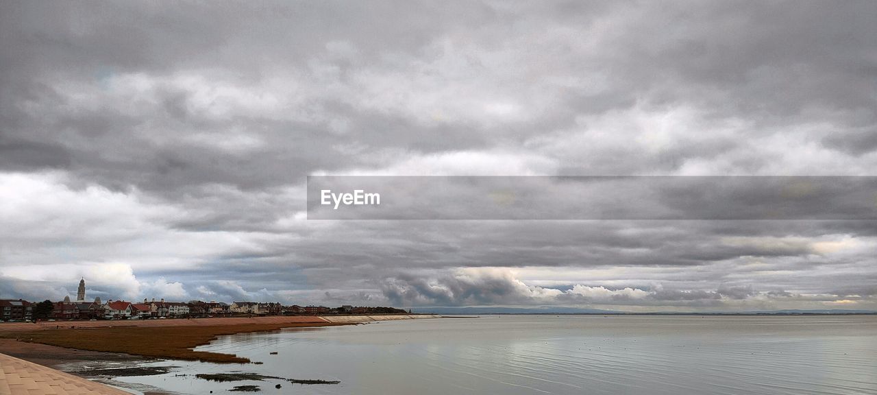 cloud, water, sky, environment, sea, horizon, landscape, beauty in nature, scenics - nature, shore, nature, land, coast, dramatic sky, storm, travel destinations, beach, overcast, travel, cloudscape, no people, storm cloud, ocean, outdoors, tourism, morning, tranquility, body of water, day, wave, reflection, architecture, moody sky, dusk, cold temperature, tranquil scene, wet, lagoon