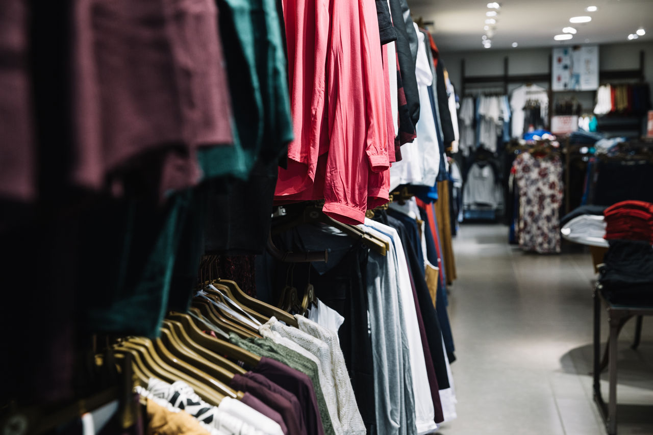 Clothes hanging in rack at market