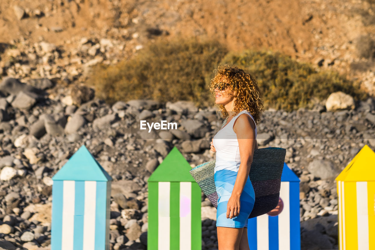 Side view of woman standing at beach