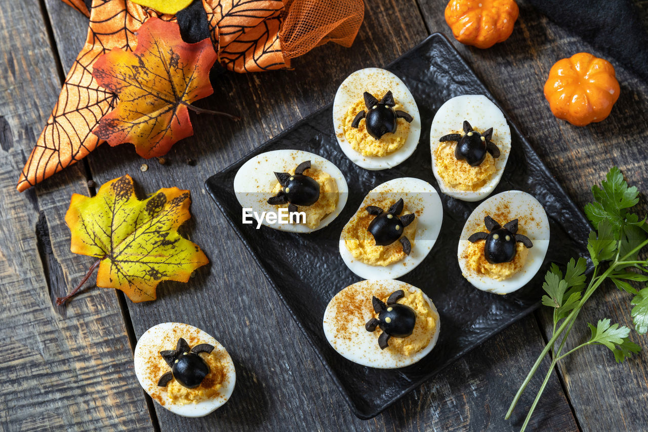 Halloween funny idea for party food. halloween creative set stuffed eggs with paprica.