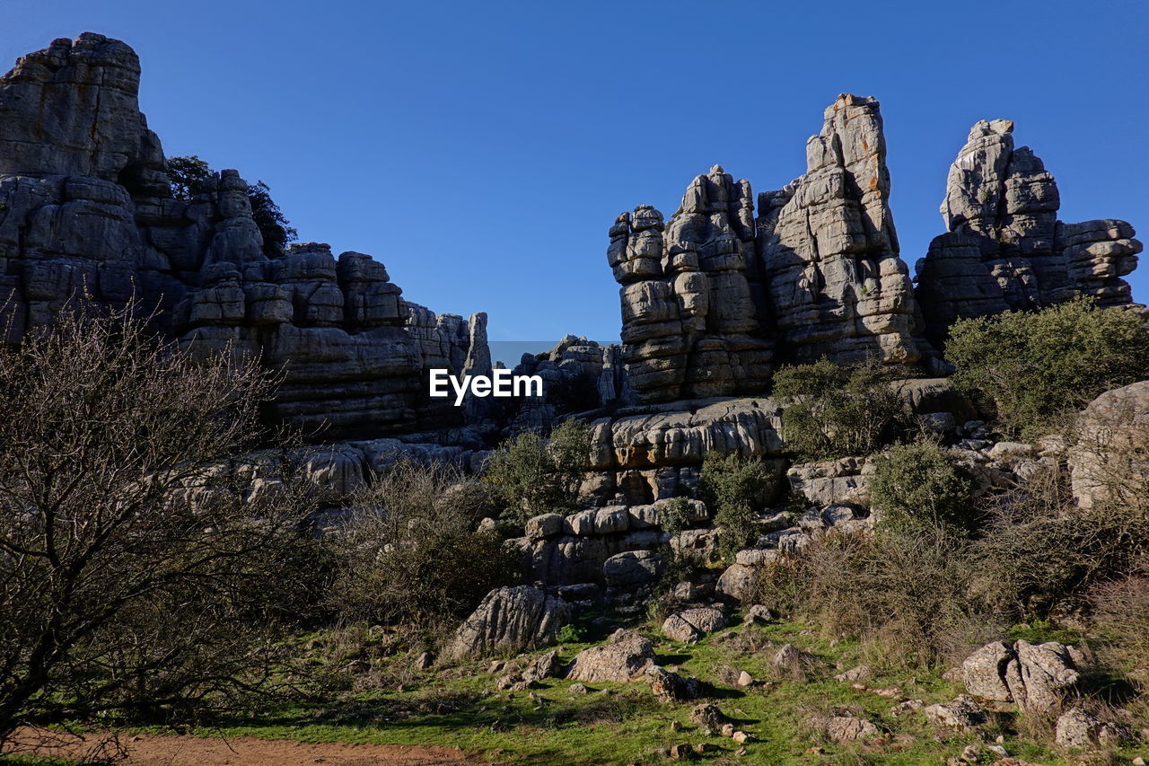 PANORAMIC VIEW OF ROCK FORMATION AGAINST CLEAR SKY
