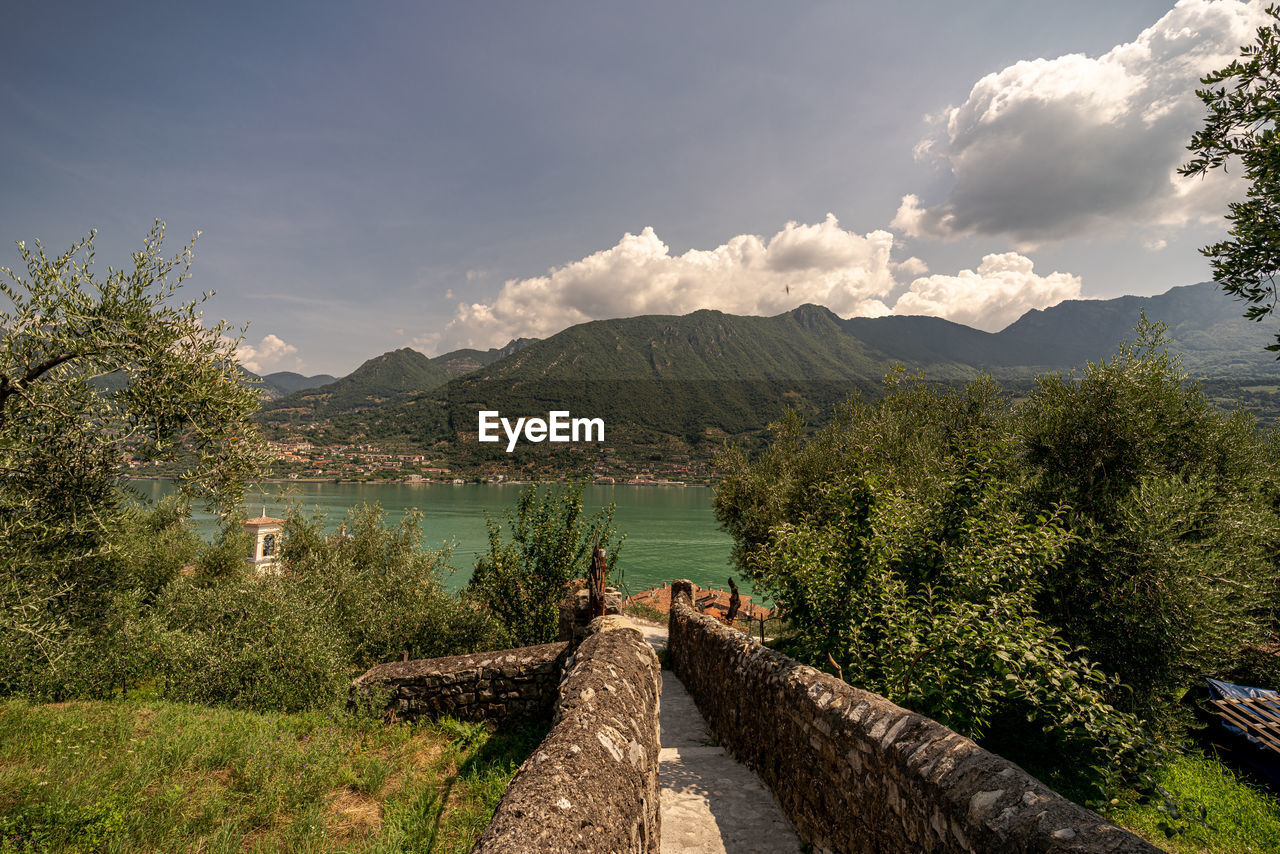 Scenic view of lake by mountains against sky