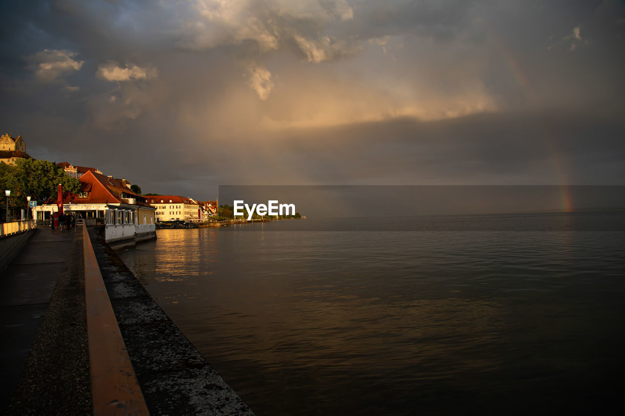 pier over sea against sky during sunset