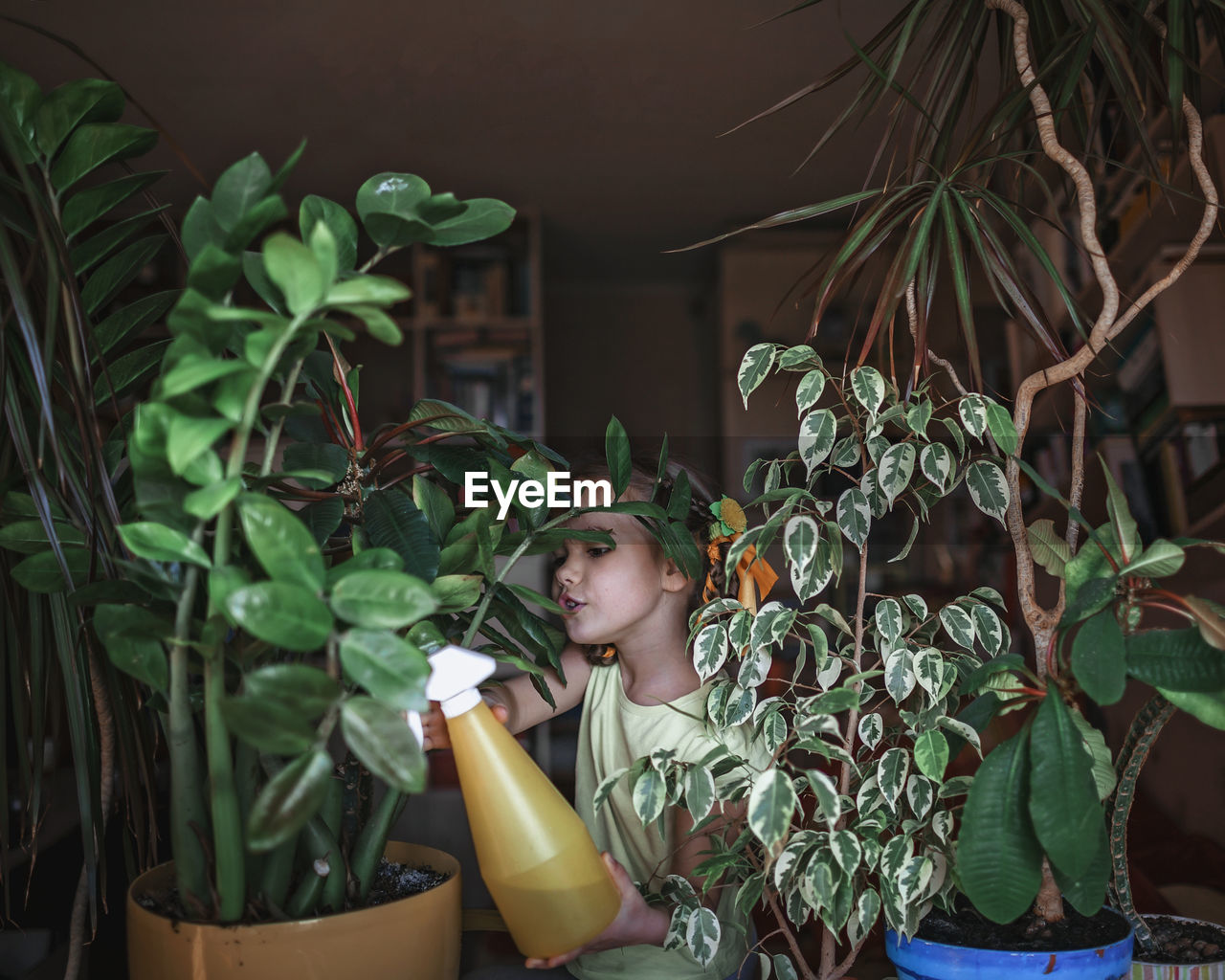 PORTRAIT OF WOMAN IN POTTED PLANT