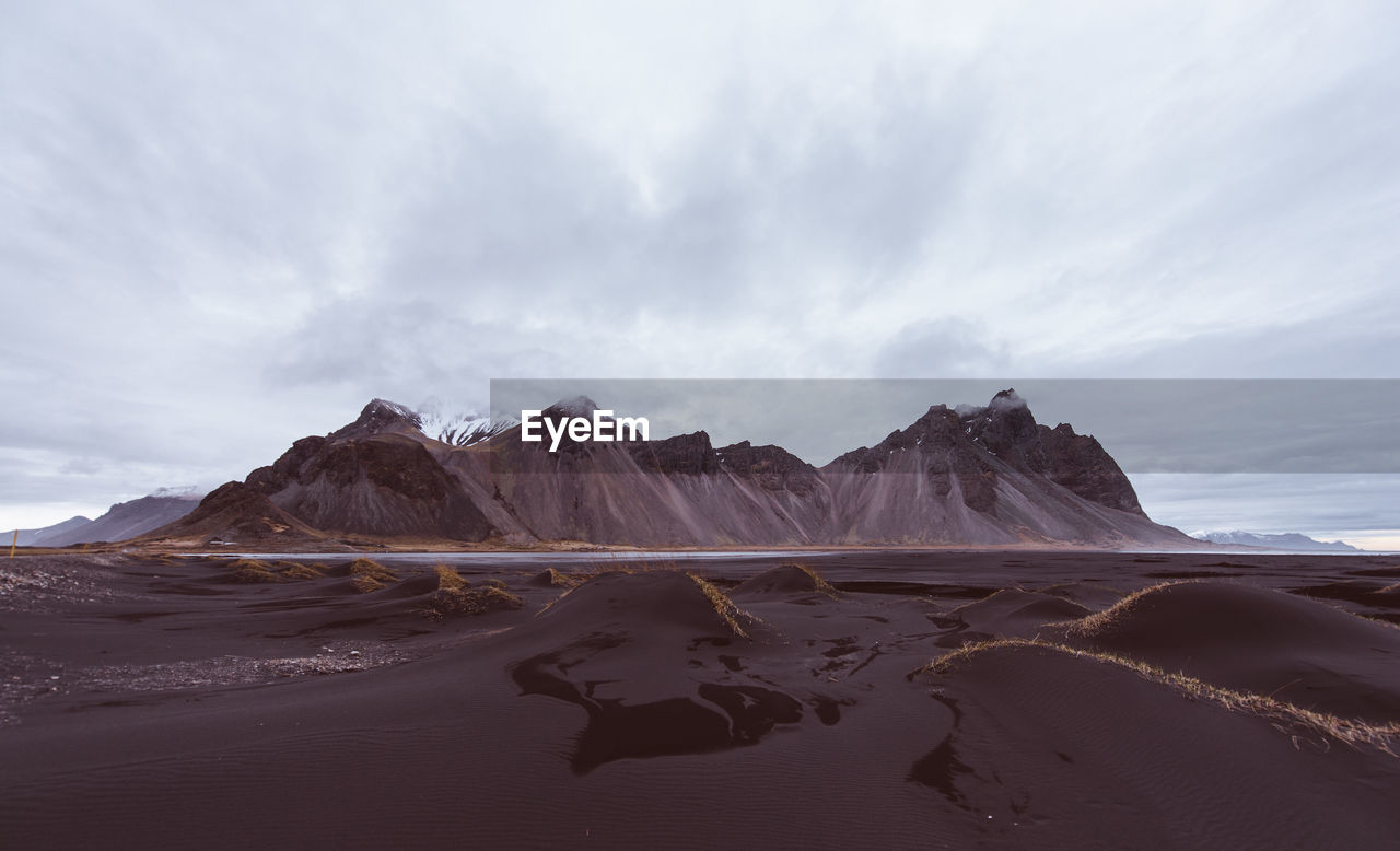 Panoramic view of sea and mountains against sky