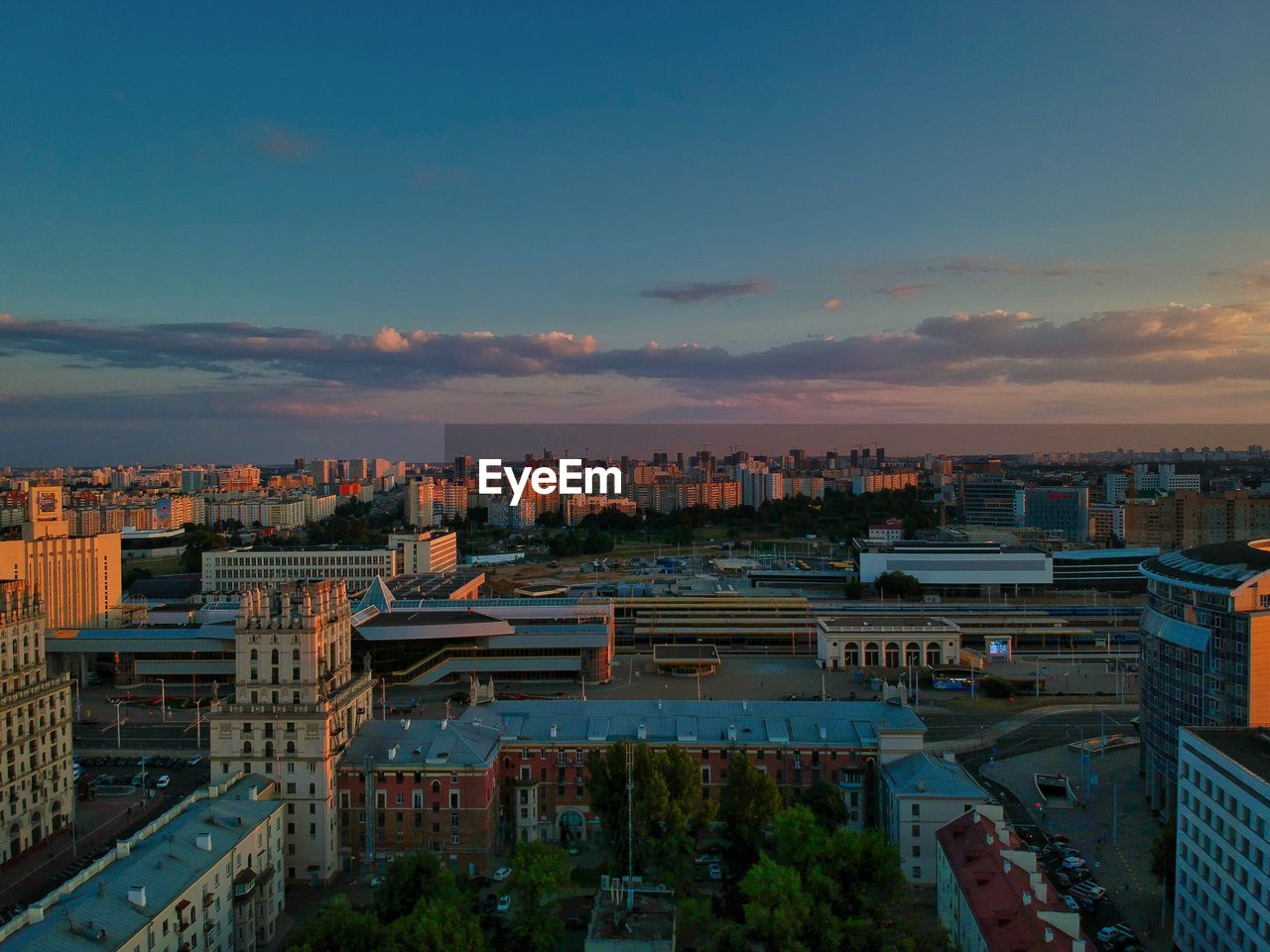 High angle view of city buildings against sky during sunset