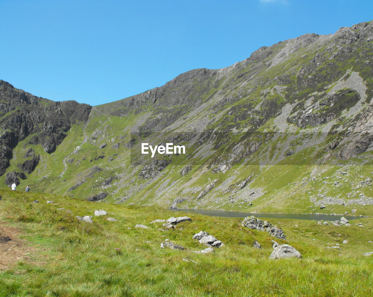 Scenic view of mountains against clear blue sky