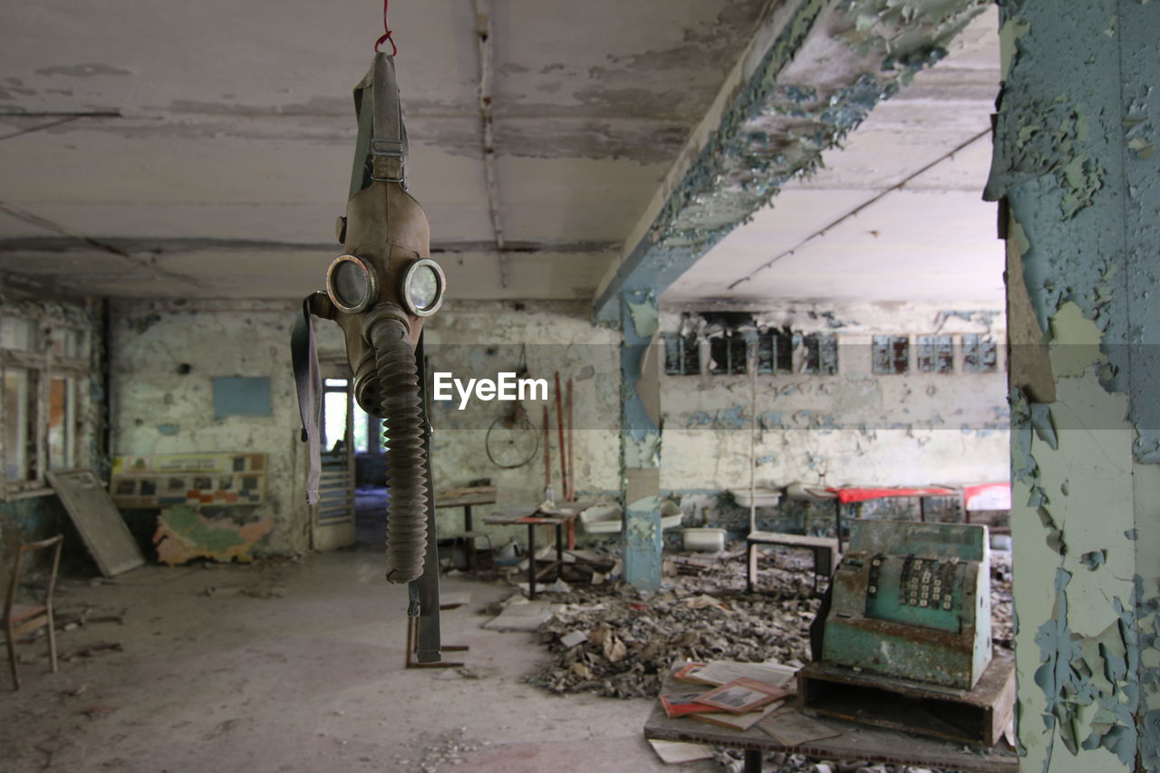 Gas mask hanging in abandoned building