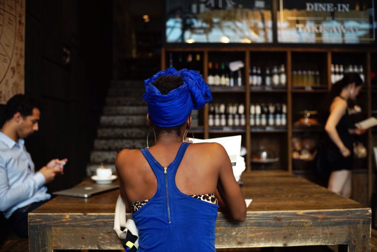 People by wooden table at cafe