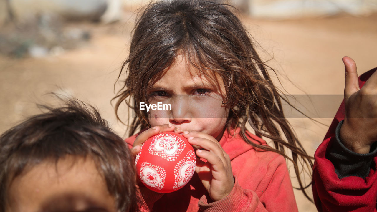 Portrait of young girl in a syrian refugee camp. 