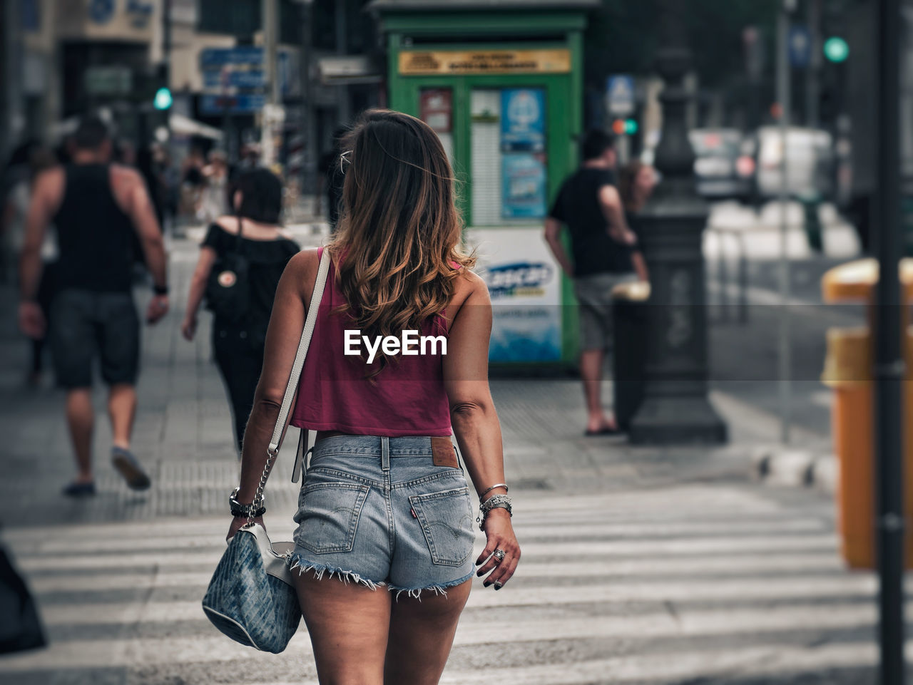 FULL LENGTH REAR VIEW OF WOMAN WALKING ON STREET