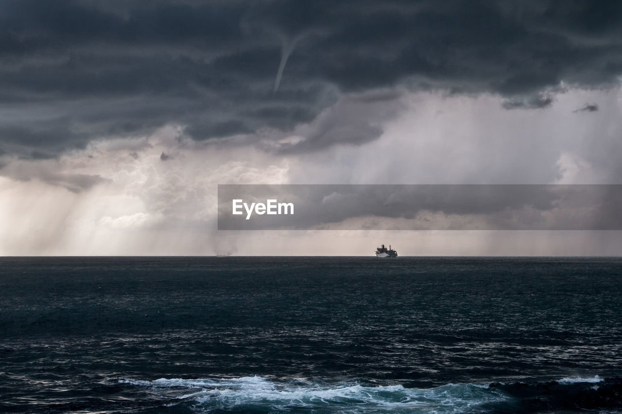 Scenic view of sea against cloudy sky