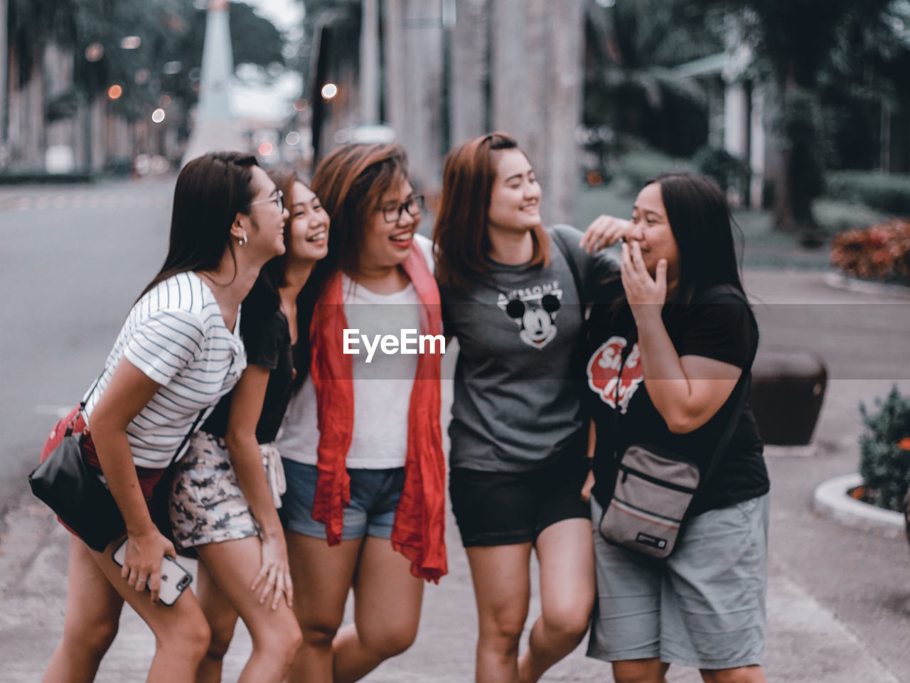 YOUNG WOMEN STANDING ON STREET