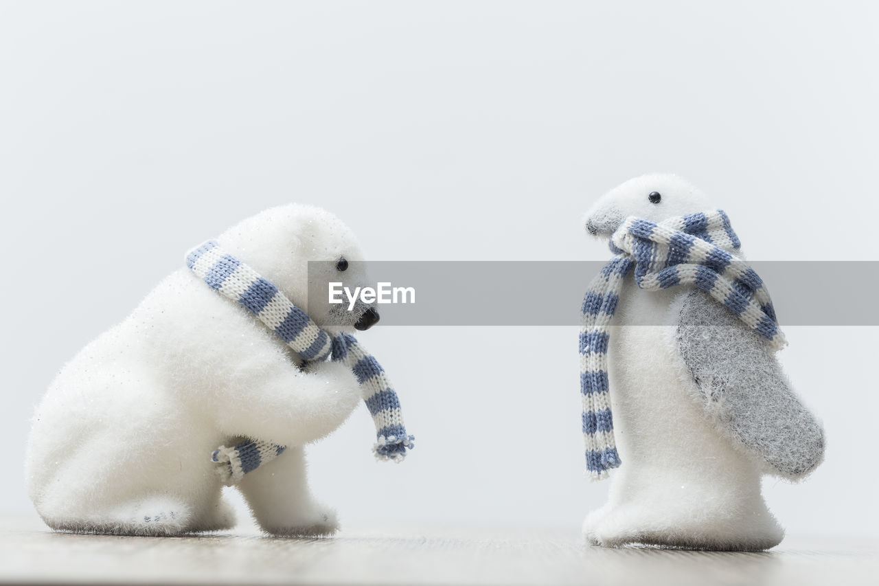 Close-up of toys against white background on table