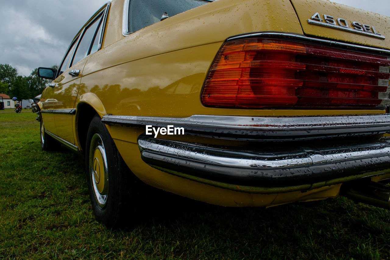 CLOSE-UP OF YELLOW CAR ON ROAD