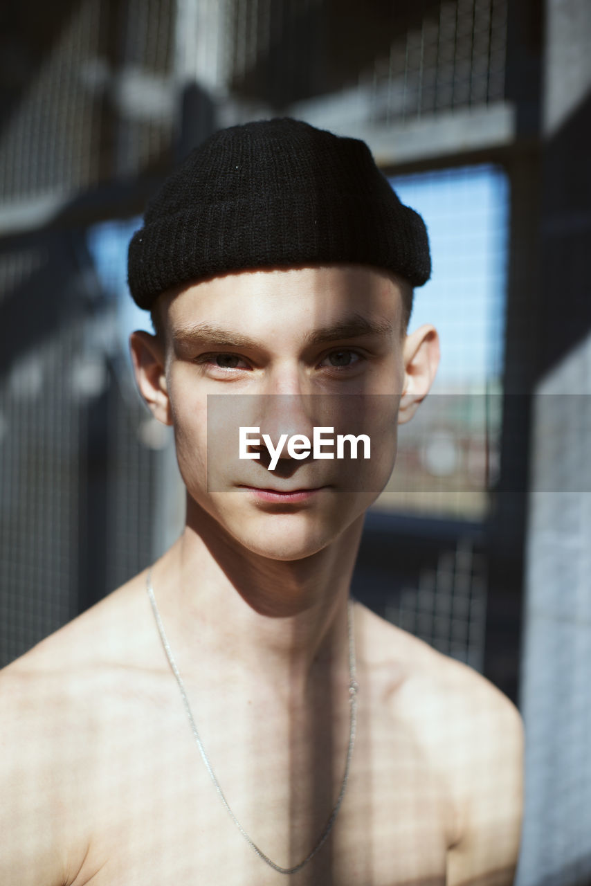 Portrait of shirtless young man wearing hat