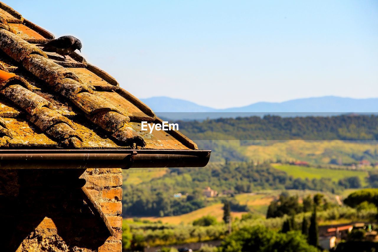 BUILT STRUCTURE ON MOUNTAIN AGAINST CLEAR SKY