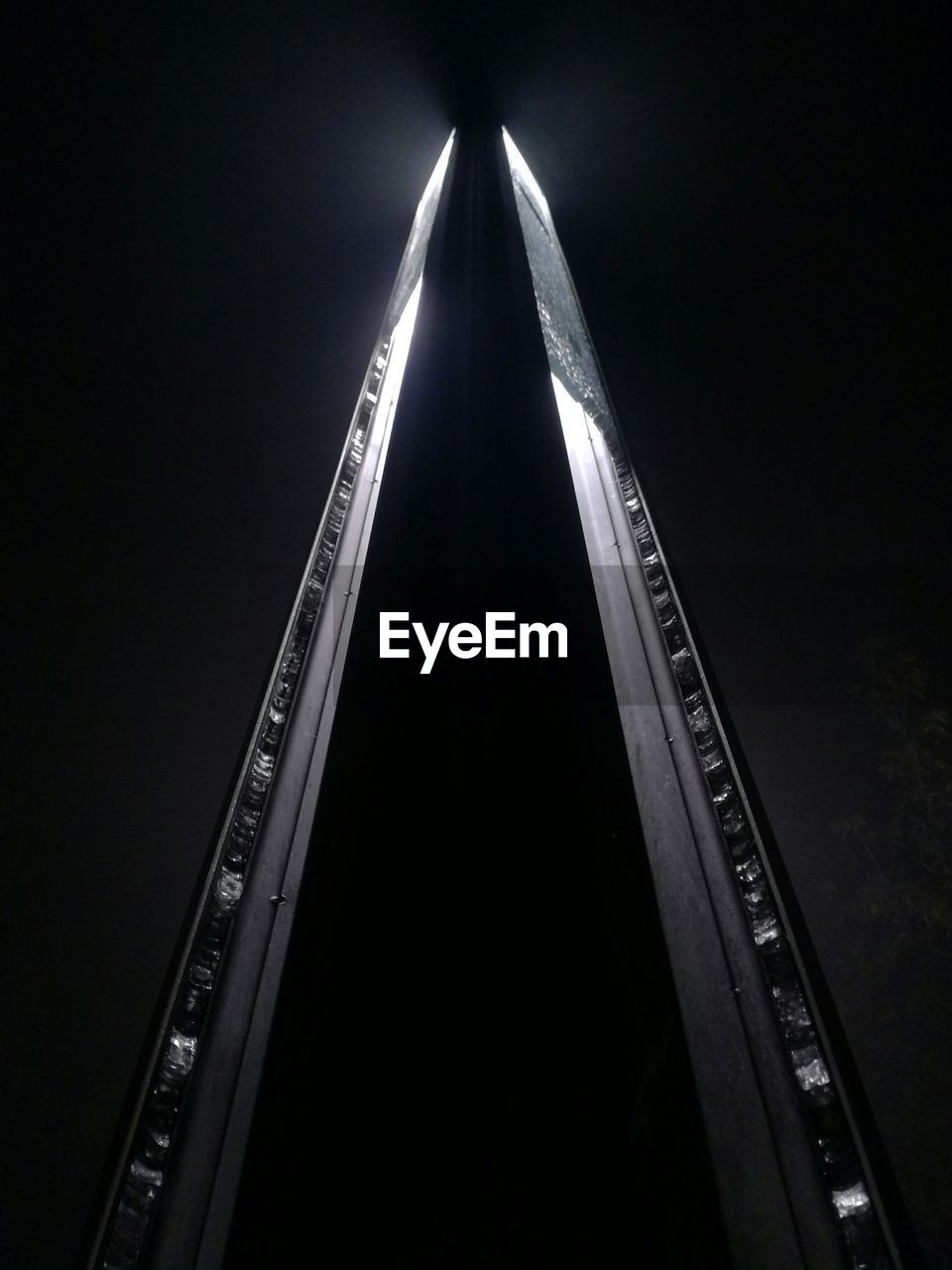 LOW ANGLE VIEW OF ILLUMINATED LIGHTS AGAINST SKY