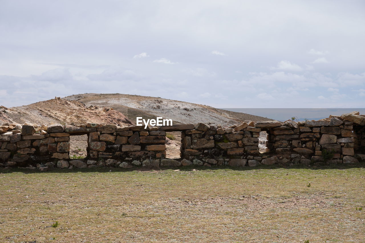 architecture, ruins, wall, sky, rock, built structure, ancient history, nature, cloud, rural area, no people, stone wall, history, building exterior, building, the past, day, archaeological site, stone material, outdoors, landscape, land, environment, house, industry, fortification, ancient