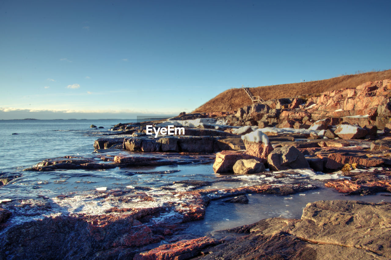 Scenic view of sea against clear sky during winter