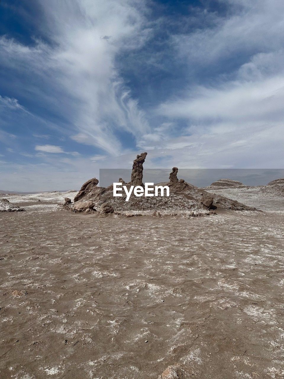 low angle view of rock formations on beach against sky