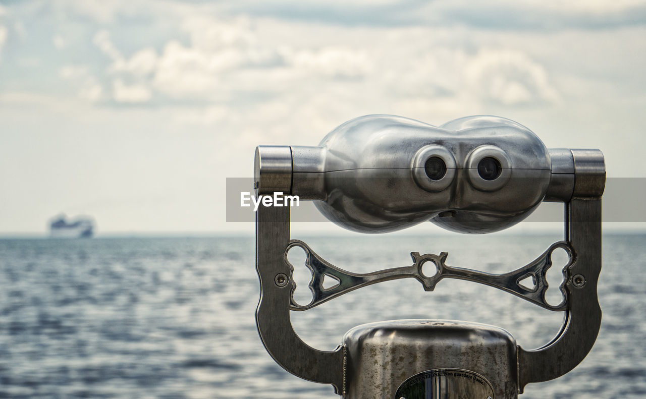 binoculars, coin operated, coin-operated binoculars, sea, sky, water, nature, focus on foreground, day, no people, surveillance, cloud, scenics - nature, outdoors, security, hand-held telescope, observation point, close-up, travel, travel destinations, horizon, tourism, blue, astronomy, beauty in nature, vehicle, telescope, metal