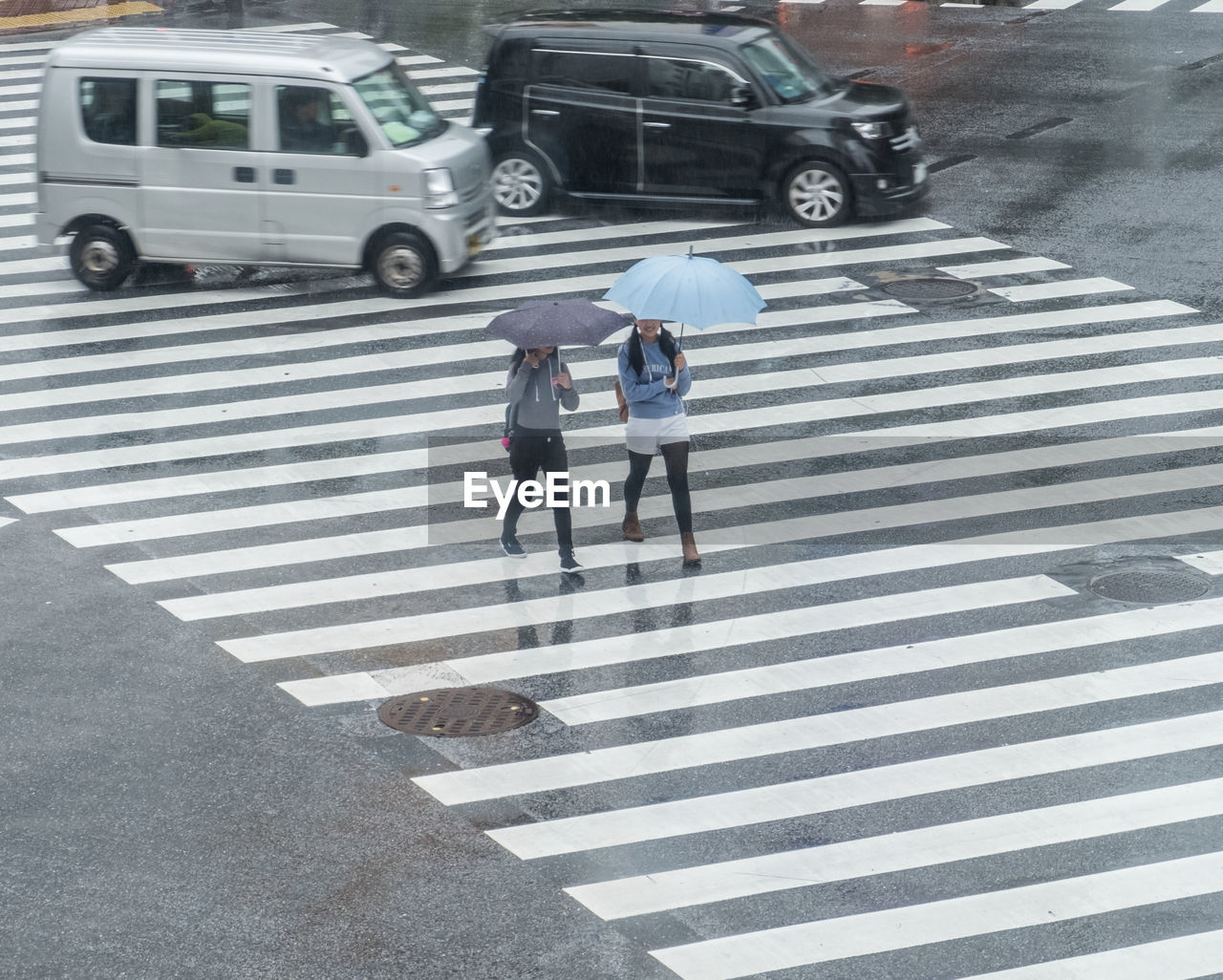 REAR VIEW OF MAN ON CITY STREET