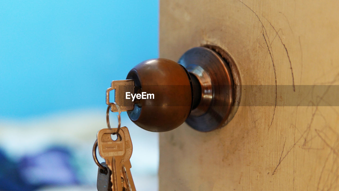 Close-up of keys against wall