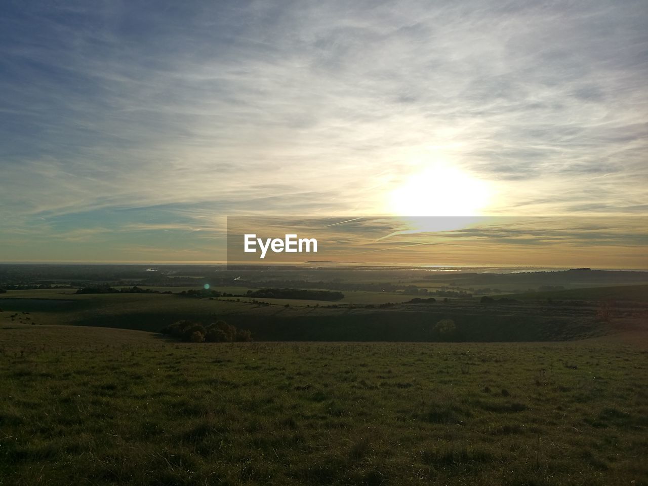 Scenic view of field against sky during sunset