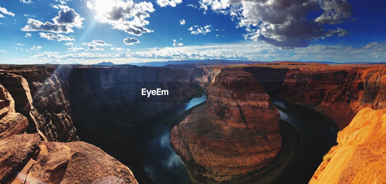 Panoramic view of horseshoe bend against sky