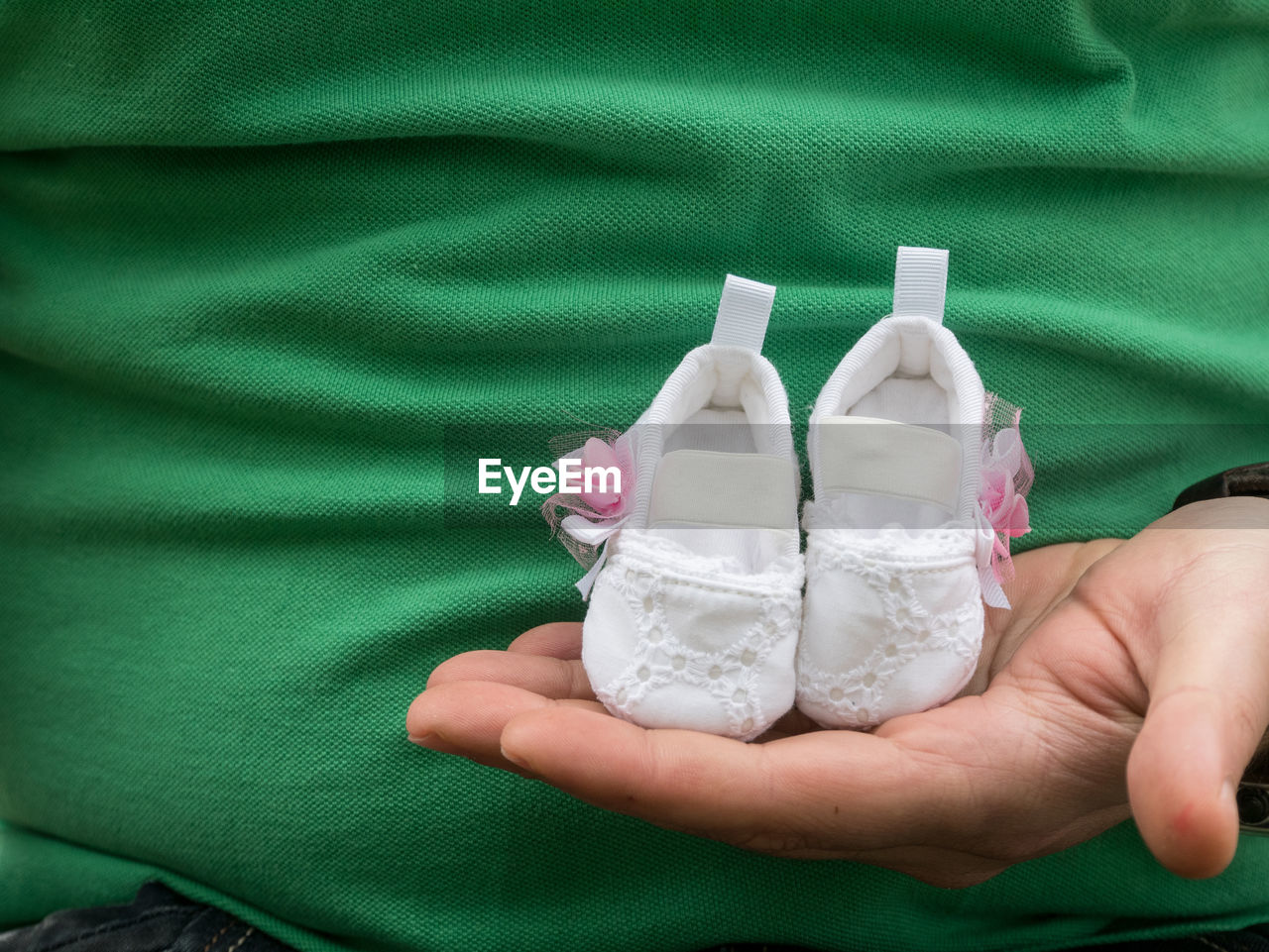 Close-up of hand holding baby booties