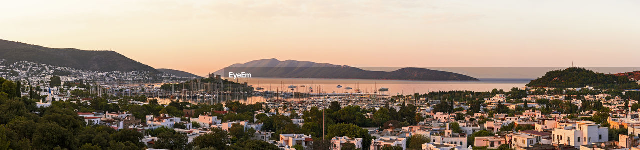 Panoramic shot of townscape against sky during sunset