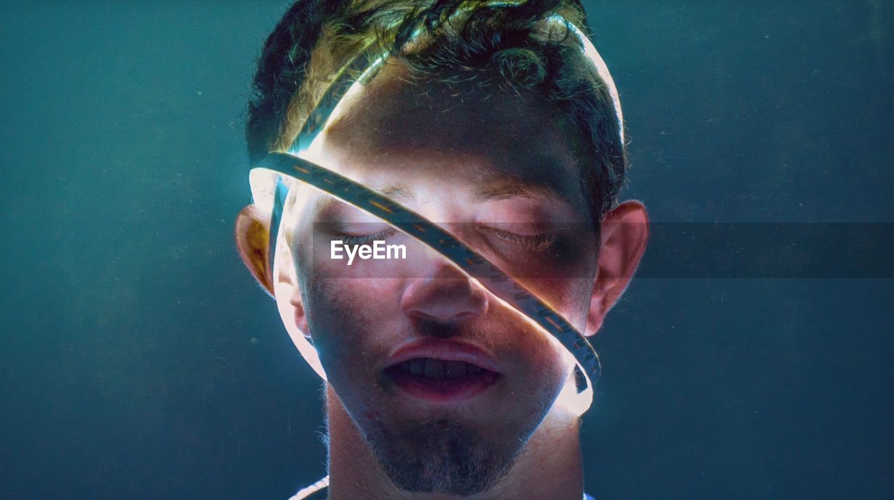 Close-up of man wearing illuminated lights in water