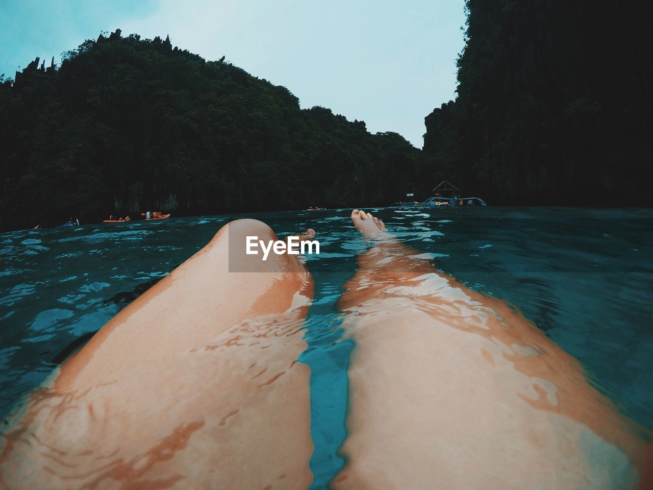 Low section of woman swimming in sea