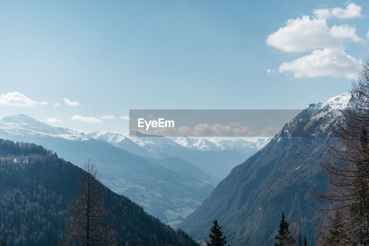 Scenic view of snow covered mountains against sky