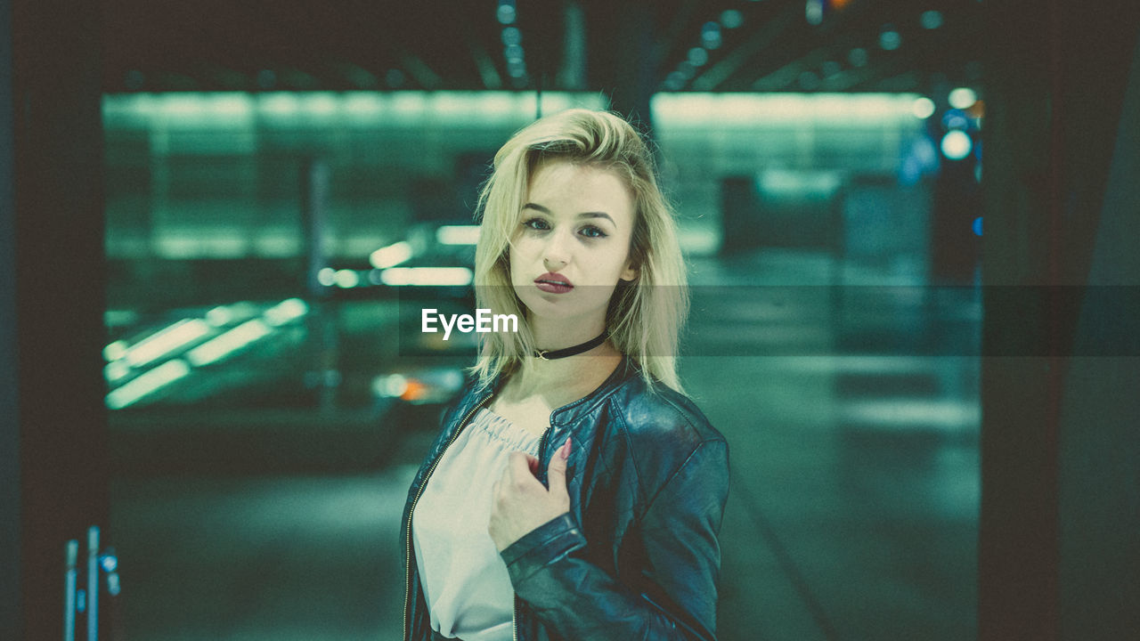 Portrait of young woman at railroad station