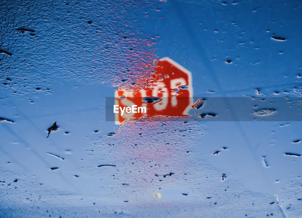 Reflection of road sign on wet floor