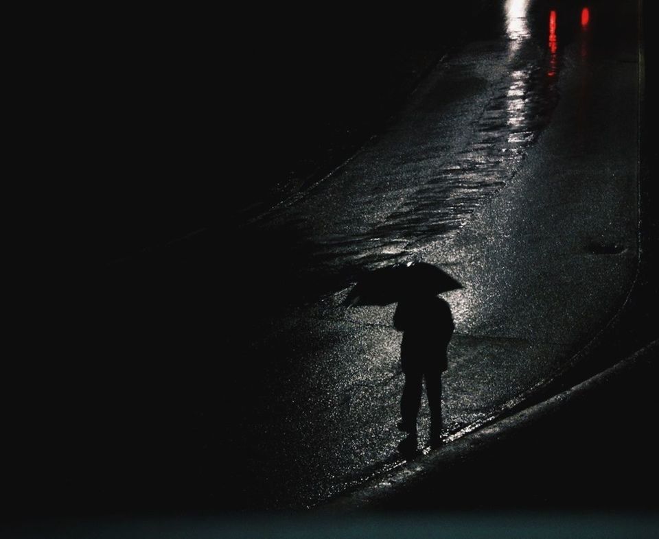 WOMAN STANDING AT NIGHT