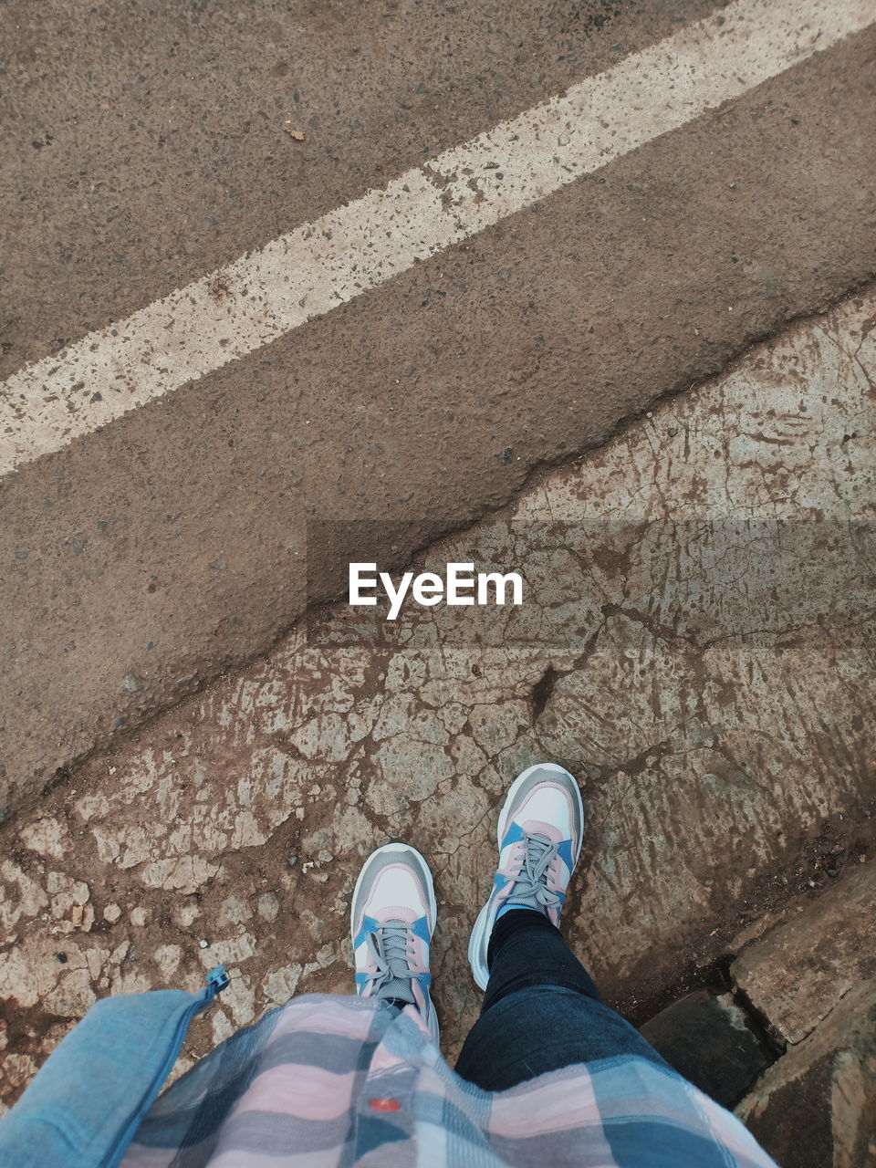 Low section of women standing on street