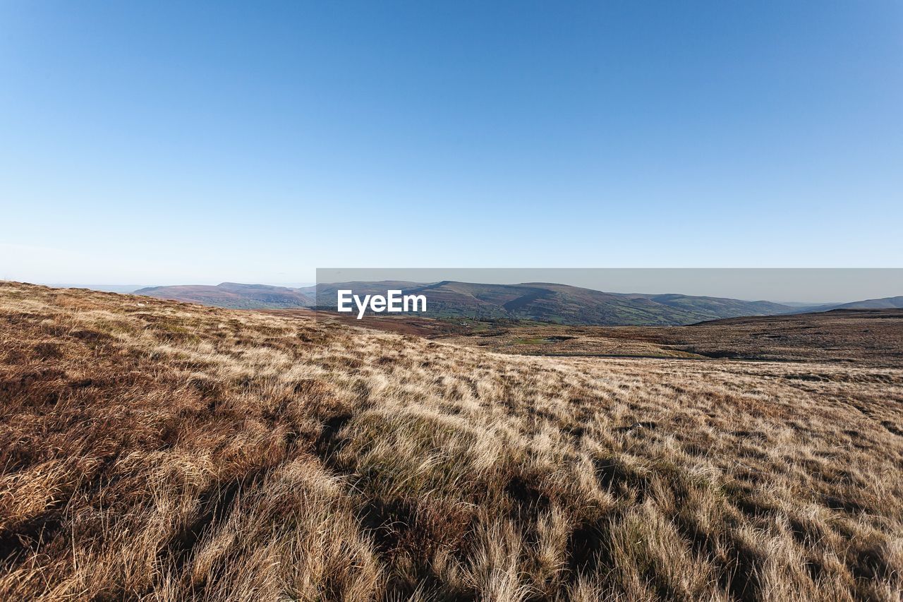 Scenic view of mountains against clear blue sky