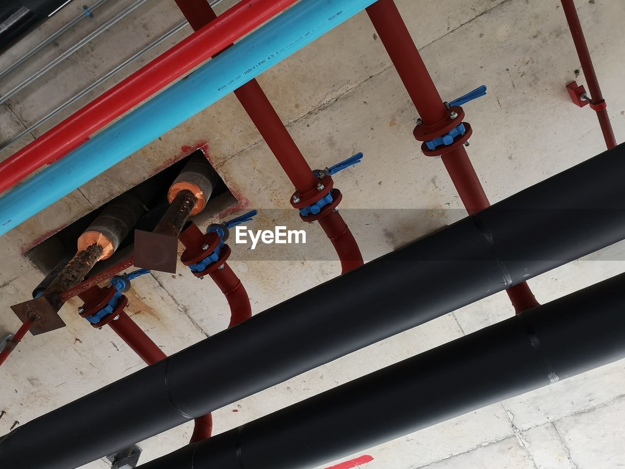 HIGH ANGLE VIEW OF PEOPLE STANDING ON PATTERNED FLOOR