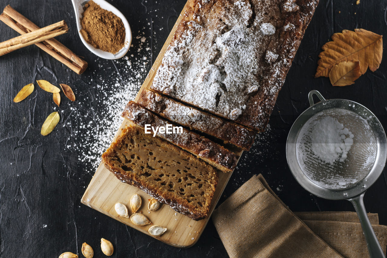 Pumpkin sponge cake cut into slices with powdered sugar on top