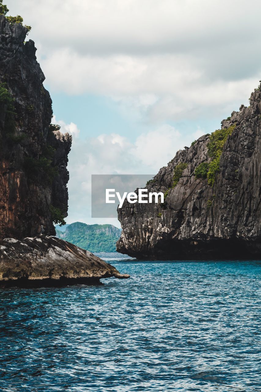 Scenic view of sea and mountains against sky