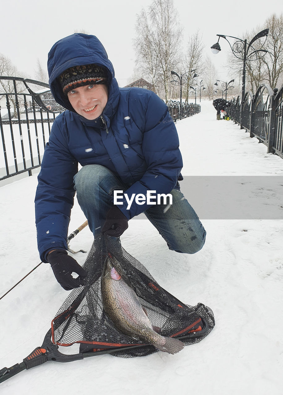 SMILING BOY WITH SNOW ON SNOWY DAY